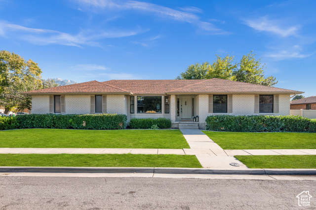 Single story home featuring a front yard