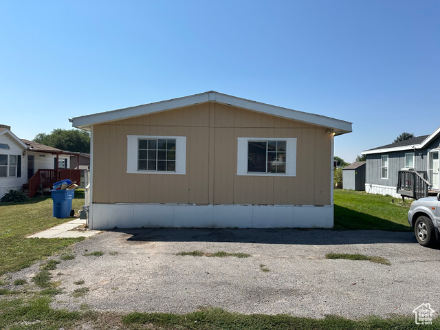 View of side of property with a yard