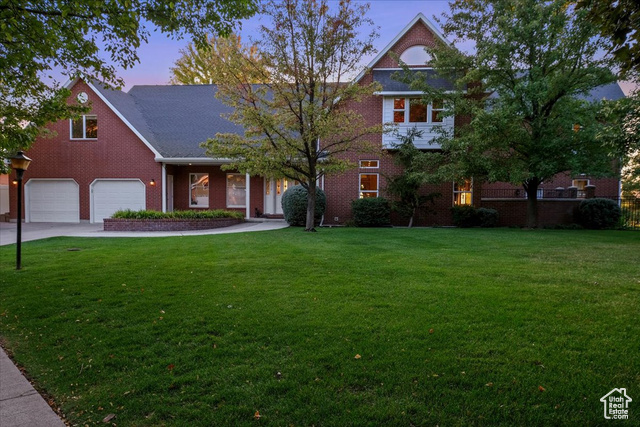 All brick home exudes a sense of grandeur and timeless elegance with full landscaping