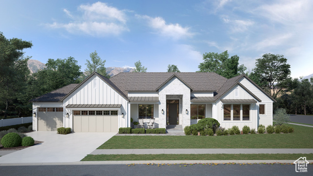 Modern inspired farmhouse featuring a garage and a front yard