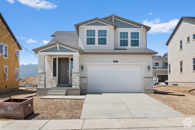 View of front of house featuring a mountain view and a garage