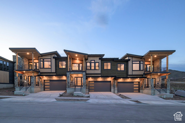 Modern home featuring a garage and a balcony