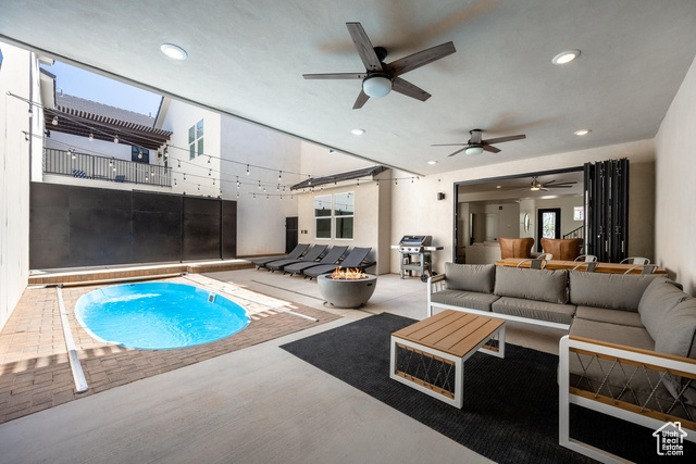 View of swimming pool featuring ceiling fan