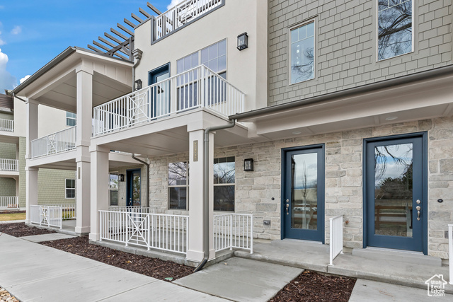 Exterior space with a balcony and a porch