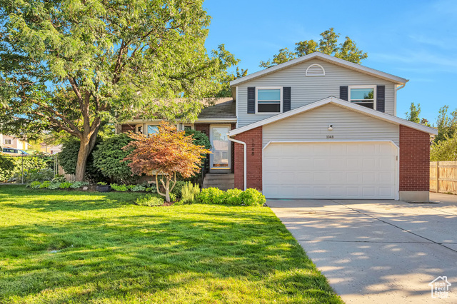 Split level home featuring a front lawn