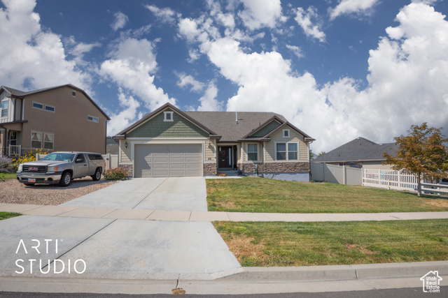 View of front of house featuring a garage and a front yard