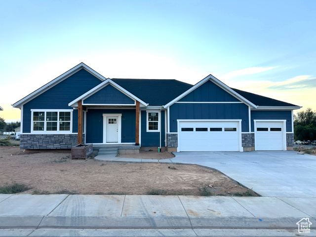 Craftsman inspired home featuring covered porch and a garage