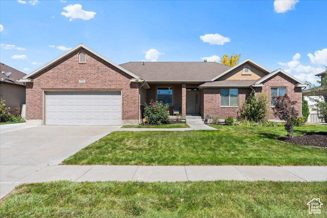 View of front of home featuring a garage and a front lawn