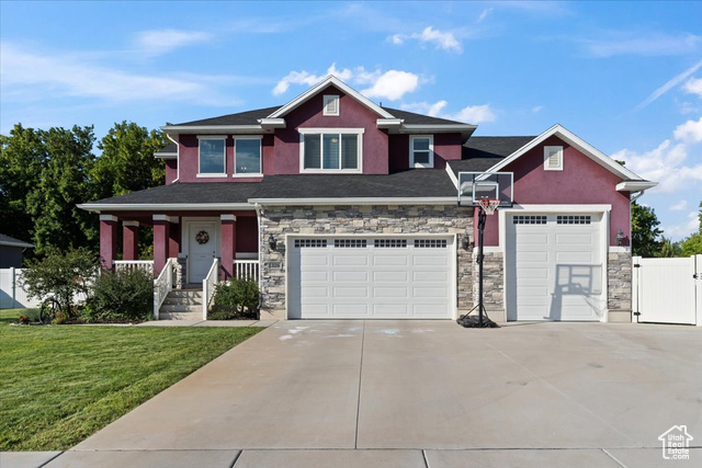 Craftsman-style home with covered porch and a front lawn