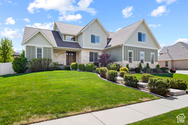 Craftsman inspired home with a front yard