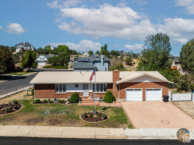 Ranch-style home featuring a front yard and a garage