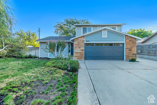 View of front facade with a front yard and a garage