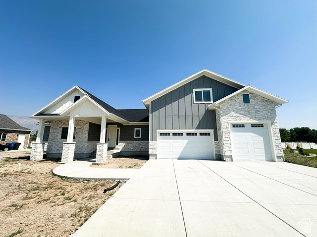 View of front of house featuring covered porch and a garage