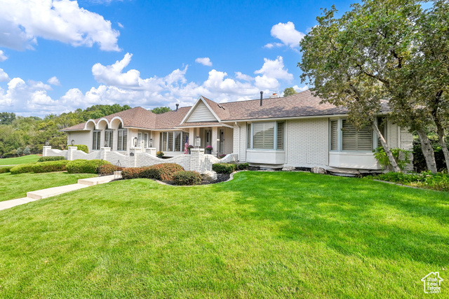 Ranch-style house with a front lawn