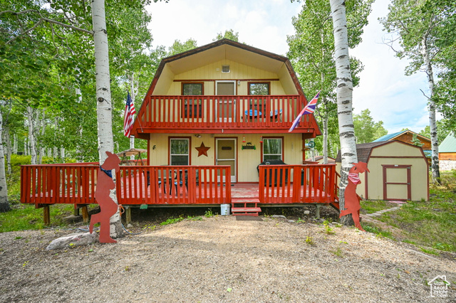 Exterior space featuring a storage shed and a deck