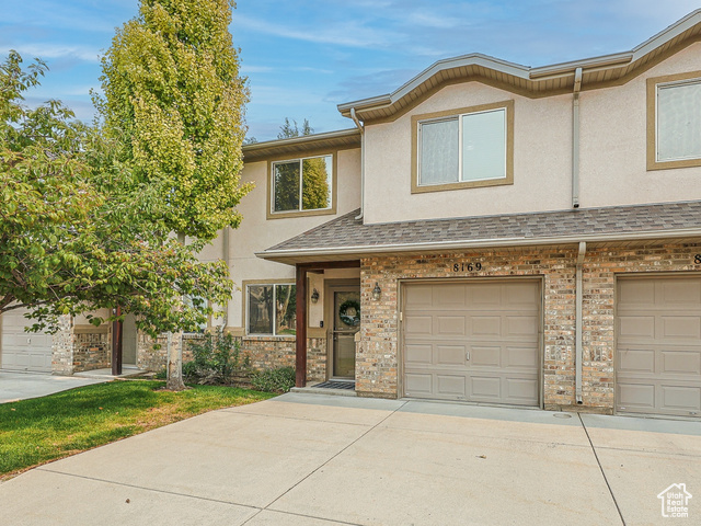 Townhome / multi-family property featuring a garage