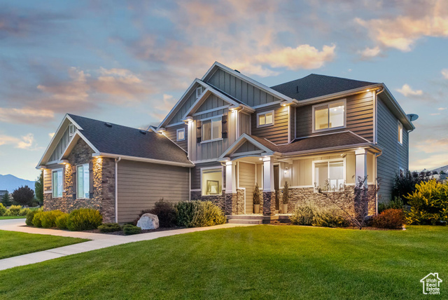 Craftsman-style home with a lawn