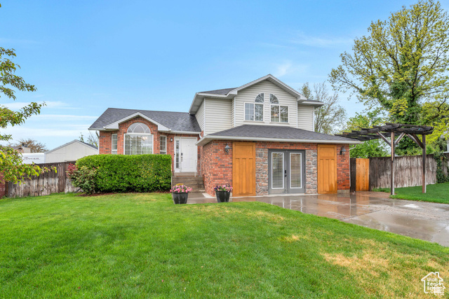 View of front of property featuring a front yard and a patio area