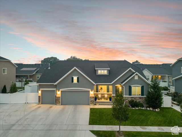 View of front of home with a lawn and a garage