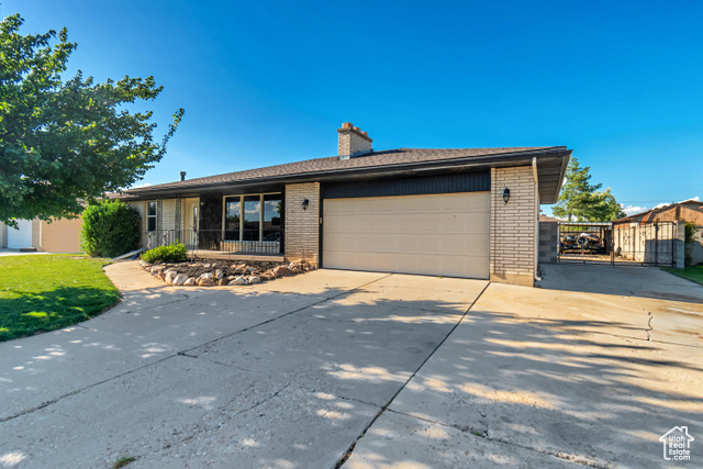 View of front of home featuring a garage and a porch