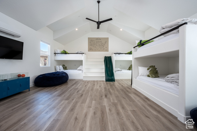 Unfurnished living room featuring lofted ceiling, ceiling fan, and light hardwood / wood-style floors