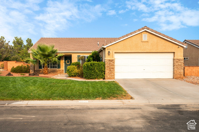 Ranch-style home with a garage and a front yard