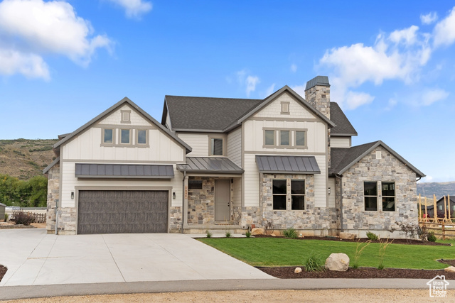 View of front of house featuring a front lawn and a 4 garage