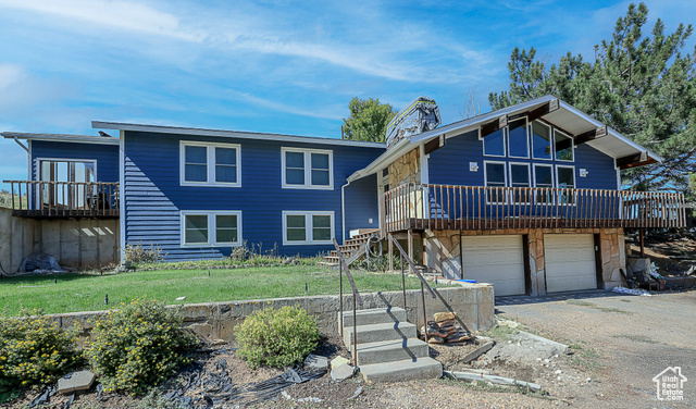 View of front of house featuring a front yard and a garage