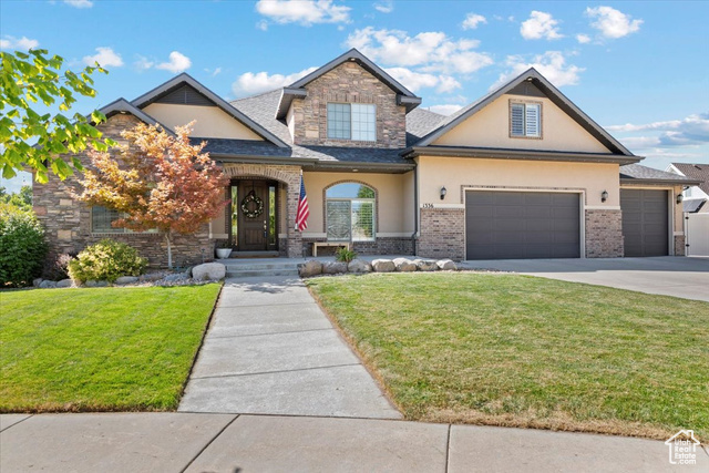 View of front of home featuring a garage and a front lawn