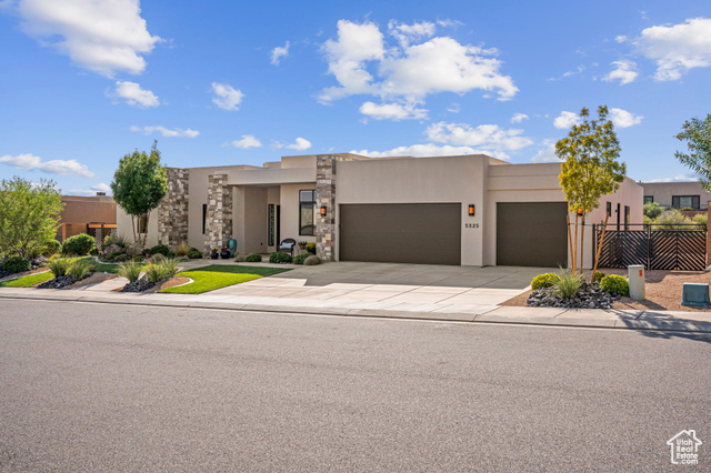 Pueblo revival-style home with a garage