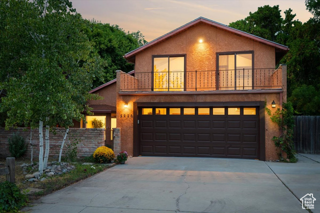 Front facade featuring a balcony and a garage