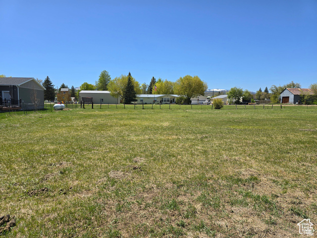 View of yard featuring a rural view and a shed