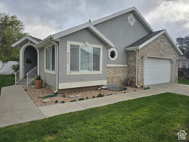 View of front facade with a front lawn and a garage