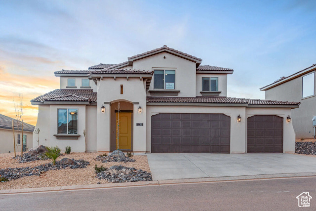 Mediterranean / spanish-style home with a garage