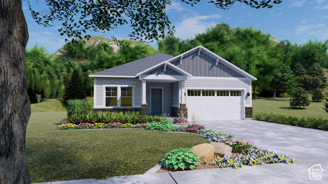 View of front of home with a garage and a front lawn