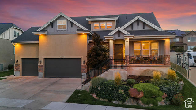 Craftsman inspired home featuring a porch and a garage