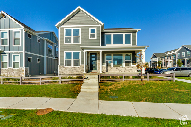 View of front of property featuring a porch and a front lawn