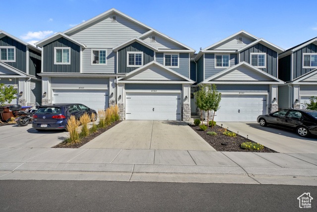 View of front facade featuring a garage