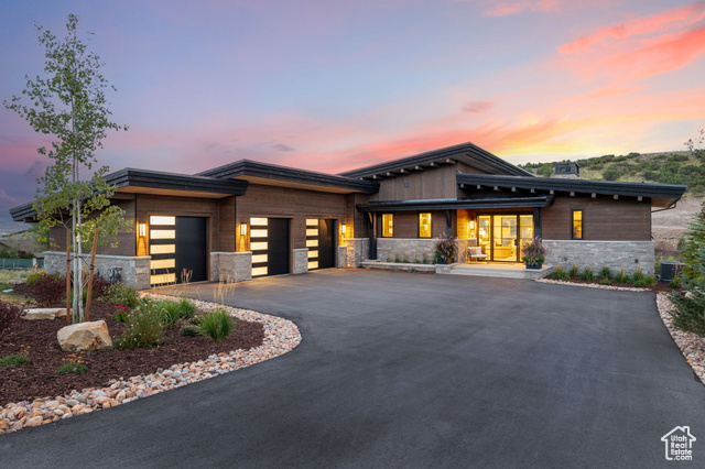 Prairie-style home with central air condition unit and a garage