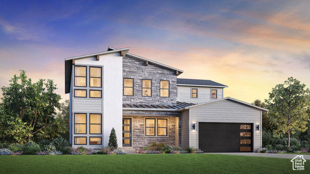 View of front facade with a garage and a yard