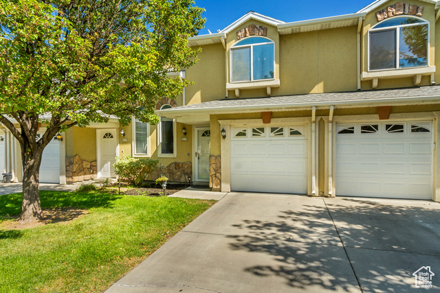 Townhome / multi-family property with a garage