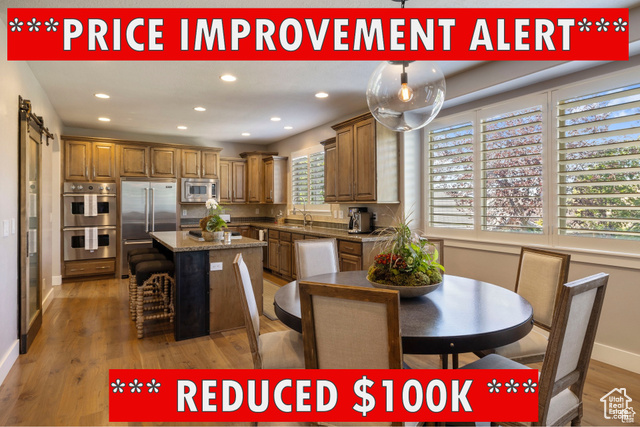 Kitchen with sink, dark wood-type flooring, built in appliances, decorative backsplash, and a kitchen island