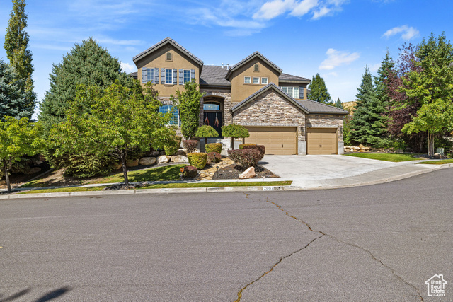 Exterior front facade of house w/ 3-Car Garage & matured landscaped yard.