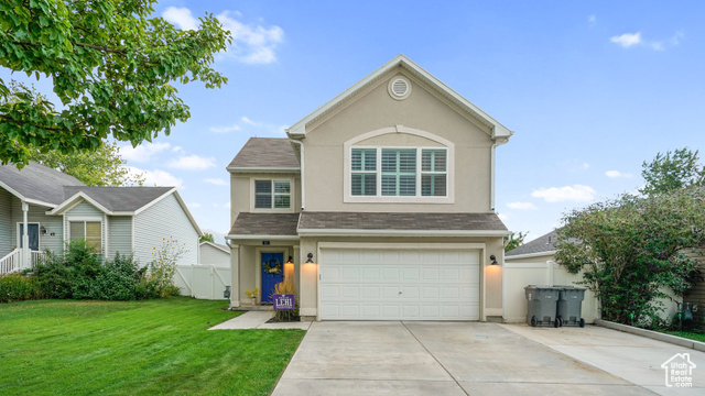 Front of property featuring a garage and a front lawn