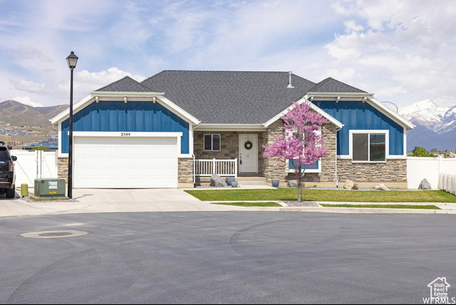 Craftsman inspired home featuring a mountain view and a garage