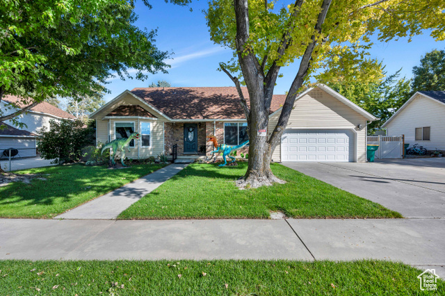 Front Yard with beautiful mature shade trees and 2 car garage