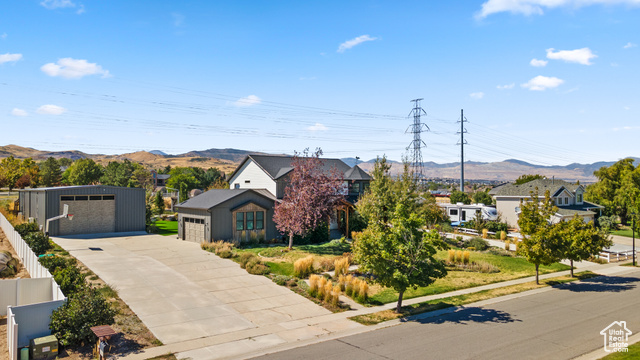 View of front of property with an outbuilding, a garage, and a mountain view