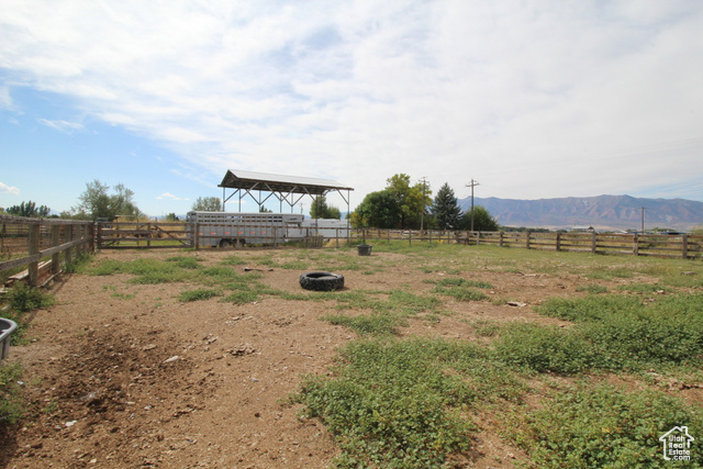 View of yard with a rural view and a mountain view