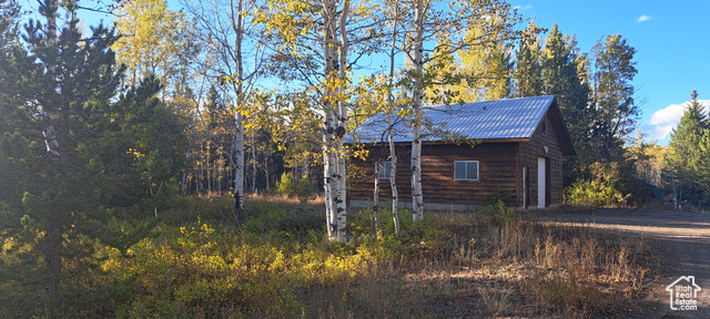 View of side of property featuring an outdoor structure and a garage