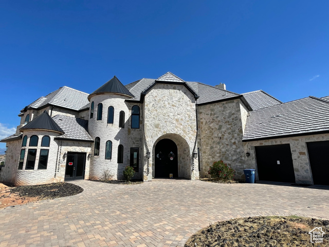 French provincial home with a garage